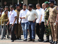 Sri Lankan president Anura Kumara Dissanayake acknowledges a differently-abled supporter after casting his vote for the parliamentary electi...