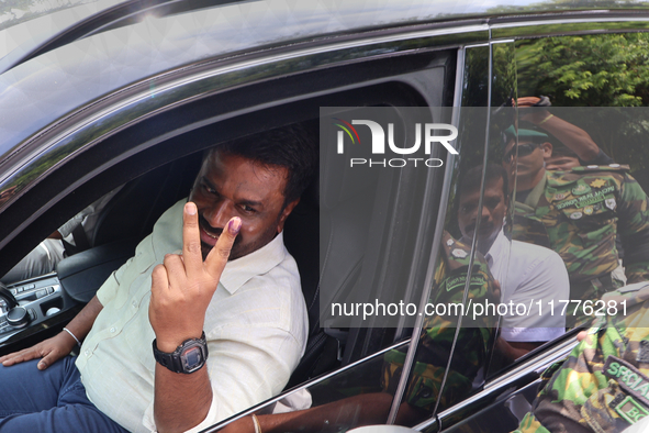 Sri Lankan president Anura Kumara Dissanayake acknowledges his supporters after casting his vote for the parliamentary election in Colombo,...