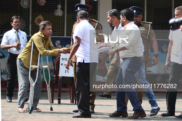 Sri Lankan president Anura Kumara Dissanayake acknowledges a differently-abled supporter after casting his vote for the parliamentary electi...