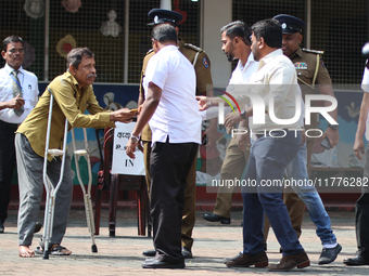 Sri Lankan president Anura Kumara Dissanayake acknowledges a differently-abled supporter after casting his vote for the parliamentary electi...