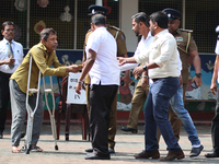 Sri Lankan president Anura Kumara Dissanayake acknowledges a differently-abled supporter after casting his vote for the parliamentary electi...