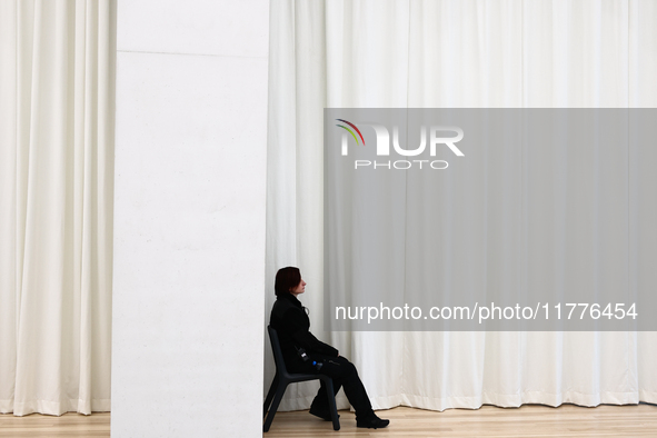 A museum worker sits inside the Modern Art in Warsaw in Warsaw, Poland on November 14, 2024. 