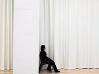 A museum worker sits inside the Modern Art in Warsaw in Warsaw, Poland on November 14, 2024. (