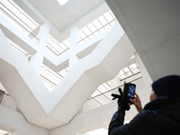 A visitor takes a photo inside the Museum of Modern Art in Warsaw in Warsaw, Poland on November 14, 2024. (