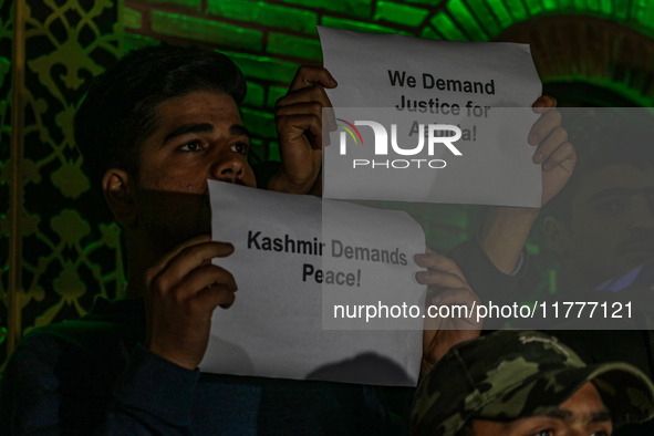 Members of the 'Save Youth Save Future' Foundation hold candles and placards during a candlelight vigil against the recent grenade blast at...