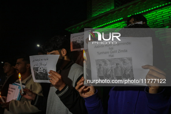 Members of the 'Save Youth Save Future' Foundation hold candles and placards during a candlelight vigil against the recent grenade blast at...