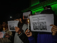 Members of the 'Save Youth Save Future' Foundation hold candles and placards during a candlelight vigil against the recent grenade blast at...