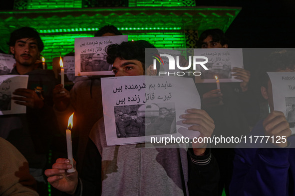 Members of the 'Save Youth Save Future' Foundation hold candles and placards during a candlelight vigil against the recent grenade blast at...