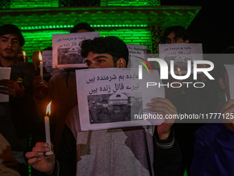 Members of the 'Save Youth Save Future' Foundation hold candles and placards during a candlelight vigil against the recent grenade blast at...