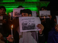 Members of the 'Save Youth Save Future' Foundation hold candles and placards during a candlelight vigil against the recent grenade blast at...