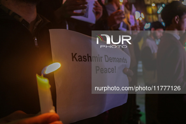 Members of the 'Save Youth Save Future' Foundation hold candles and placards during a candlelight vigil against the recent grenade blast at...