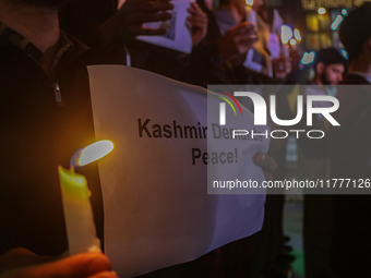 Members of the 'Save Youth Save Future' Foundation hold candles and placards during a candlelight vigil against the recent grenade blast at...