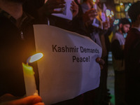 Members of the 'Save Youth Save Future' Foundation hold candles and placards during a candlelight vigil against the recent grenade blast at...