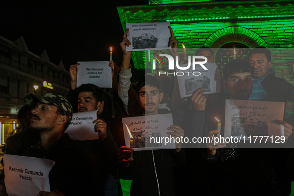 Members of the 'Save Youth Save Future' Foundation hold candles and placards during a candlelight vigil against the recent grenade blast at...