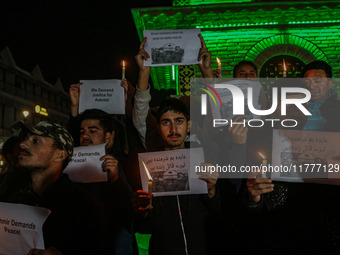 Members of the 'Save Youth Save Future' Foundation hold candles and placards during a candlelight vigil against the recent grenade blast at...