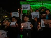 Members of the 'Save Youth Save Future' Foundation hold candles and placards during a candlelight vigil against the recent grenade blast at...