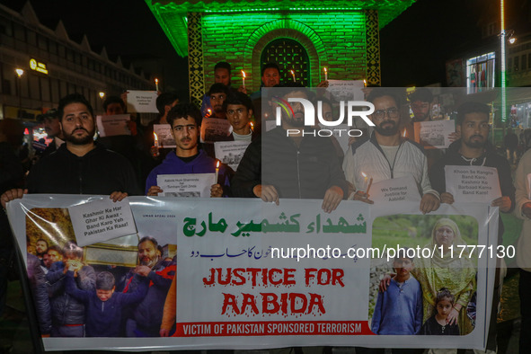 Members of the 'Save Youth Save Future' Foundation hold candles and placards during a candlelight vigil against the recent grenade blast at...