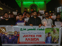 Members of the 'Save Youth Save Future' Foundation hold candles and placards during a candlelight vigil against the recent grenade blast at...