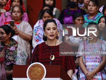 Claudia Icaza, Minister of Culture, speaks during the Original Textile Art Meeting, accompanied by indigenous craftswomen from different sta...