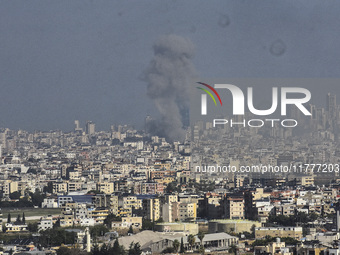 Smoke rises from a residential area after a series of Israeli airstrikes on the Dahieh region in southern Beirut, Lebanon, on November 14, 2...