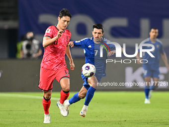 Mohammad Abdullah of Kuwait competes against Park Yongwoo of Korea Republic during the AFC Asian Qualifiers Road to 26 match between Kuwait...