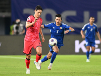 Mohammad Abdullah of Kuwait competes against Park Yongwoo of Korea Republic during the AFC Asian Qualifiers Road to 26 match between Kuwait...