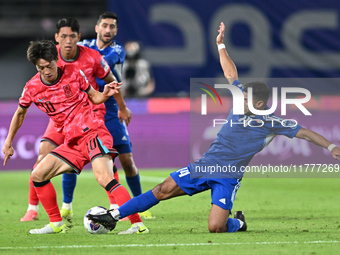 Redha Abujabarah of Kuwait competes against Lee Jaesung of Korea Republic during the AFC Asian Qualifiers Road to 26 match between Kuwait an...