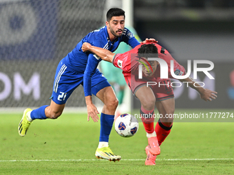 Hasan Alanezi of Kuwait competes against Kim Bongsoo of Korea Republic during the AFC Asian Qualifiers Road to 26 match between Kuwait and K...