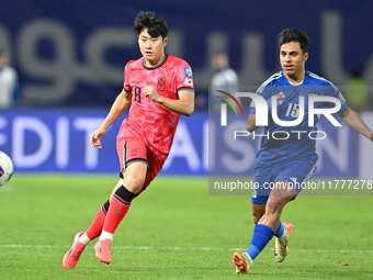 Yosef Alshammari of Kuwait competes against Park Yongwoo of Korea Republic during the AFC Asian Qualifiers Road to 26 match between Kuwait a...