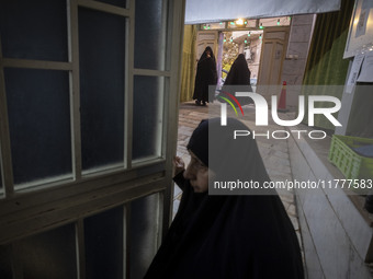 Veiled Iranian women arrive to take part in a charity ceremony for donating gold and money to help the Lebanese Resistance Front and its aff...