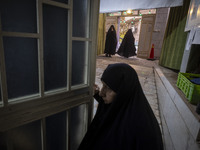 Veiled Iranian women arrive to take part in a charity ceremony for donating gold and money to help the Lebanese Resistance Front and its aff...