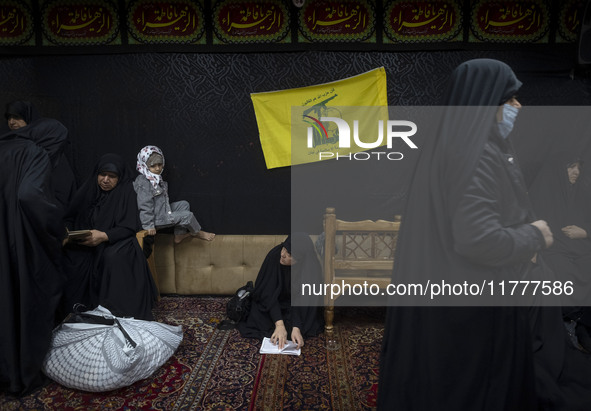 A flag of Lebanon's Hezbollah hangs at a house used as a Hosseiniyeh during a charity ceremony for donating gold and money to help the Leban...