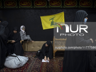 A flag of Lebanon's Hezbollah hangs at a house used as a Hosseiniyeh during a charity ceremony for donating gold and money to help the Leban...