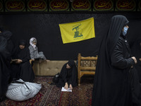 A flag of Lebanon's Hezbollah hangs at a house used as a Hosseiniyeh during a charity ceremony for donating gold and money to help the Leban...