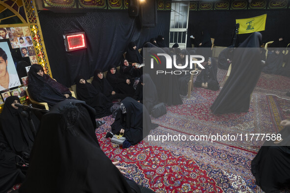 Veiled Iranian women participate in a charity ceremony to donate gold and money to help the Lebanese Resistance Front and its affected peopl...