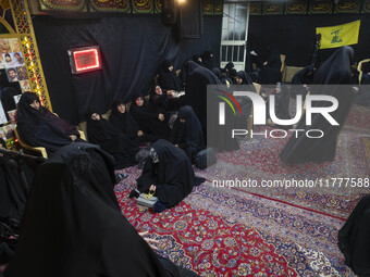 Veiled Iranian women participate in a charity ceremony to donate gold and money to help the Lebanese Resistance Front and its affected peopl...