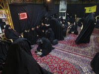 Veiled Iranian women participate in a charity ceremony to donate gold and money to help the Lebanese Resistance Front and its affected peopl...