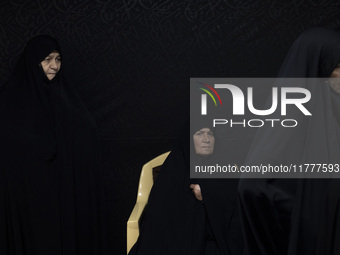 A veiled elderly Iranian woman looks on while participating in a charity ceremony for donating gold and money to help the Lebanese Resistanc...