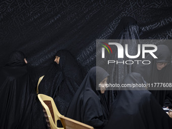 Veiled Iranian women participate in a charity ceremony to donate gold and money to help the Lebanese Resistance Front and its affected peopl...