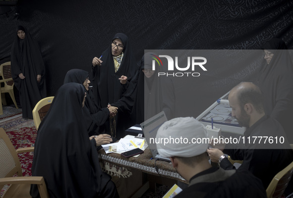 Veiled Iranian women participate in a charity ceremony to donate gold and money to help the Lebanese Resistance Front and its affected peopl...