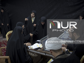 Veiled Iranian women participate in a charity ceremony to donate gold and money to help the Lebanese Resistance Front and its affected peopl...