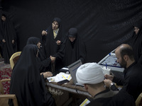 Veiled Iranian women participate in a charity ceremony to donate gold and money to help the Lebanese Resistance Front and its affected peopl...