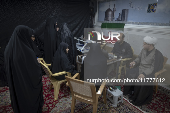 Veiled Iranian women participate in a charity ceremony to donate gold and money to help the Lebanese Resistance Front and its affected peopl...