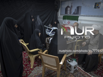 Veiled Iranian women participate in a charity ceremony to donate gold and money to help the Lebanese Resistance Front and its affected peopl...