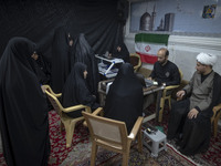 Veiled Iranian women participate in a charity ceremony to donate gold and money to help the Lebanese Resistance Front and its affected peopl...