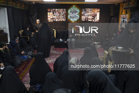 Veiled Iranian women participate in a charity ceremony to donate gold and money to help the Lebanese Resistance Front and its affected peopl...