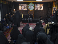 Veiled Iranian women participate in a charity ceremony to donate gold and money to help the Lebanese Resistance Front and its affected peopl...