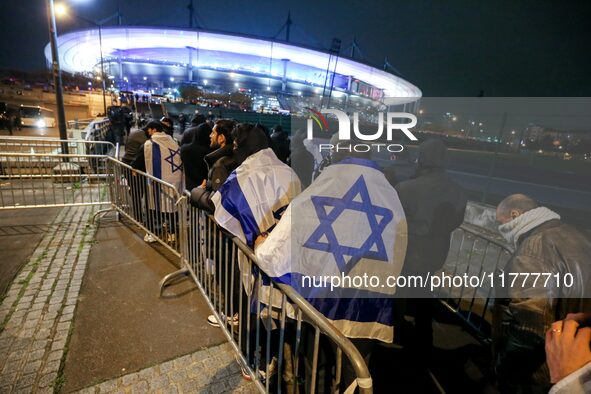 Supporters with Israeli flags queue outside the Stade de France stadium ahead of the UEFA Nations League League A, Group A2 football match b...