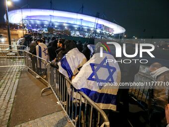 Supporters with Israeli flags queue outside the Stade de France stadium ahead of the UEFA Nations League League A, Group A2 football match b...