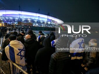 Supporters with Israeli flags queue outside the Stade de France stadium ahead of the UEFA Nations League League A, Group A2 football match b...